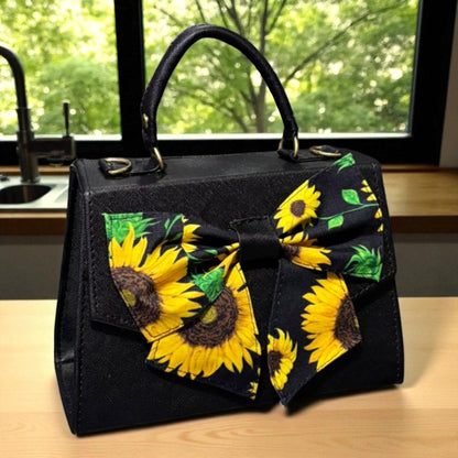 Bolsa FAUSTINA Crossbody Negra con Moño de Girasoles – Mini Tote Artesanal Moderno
